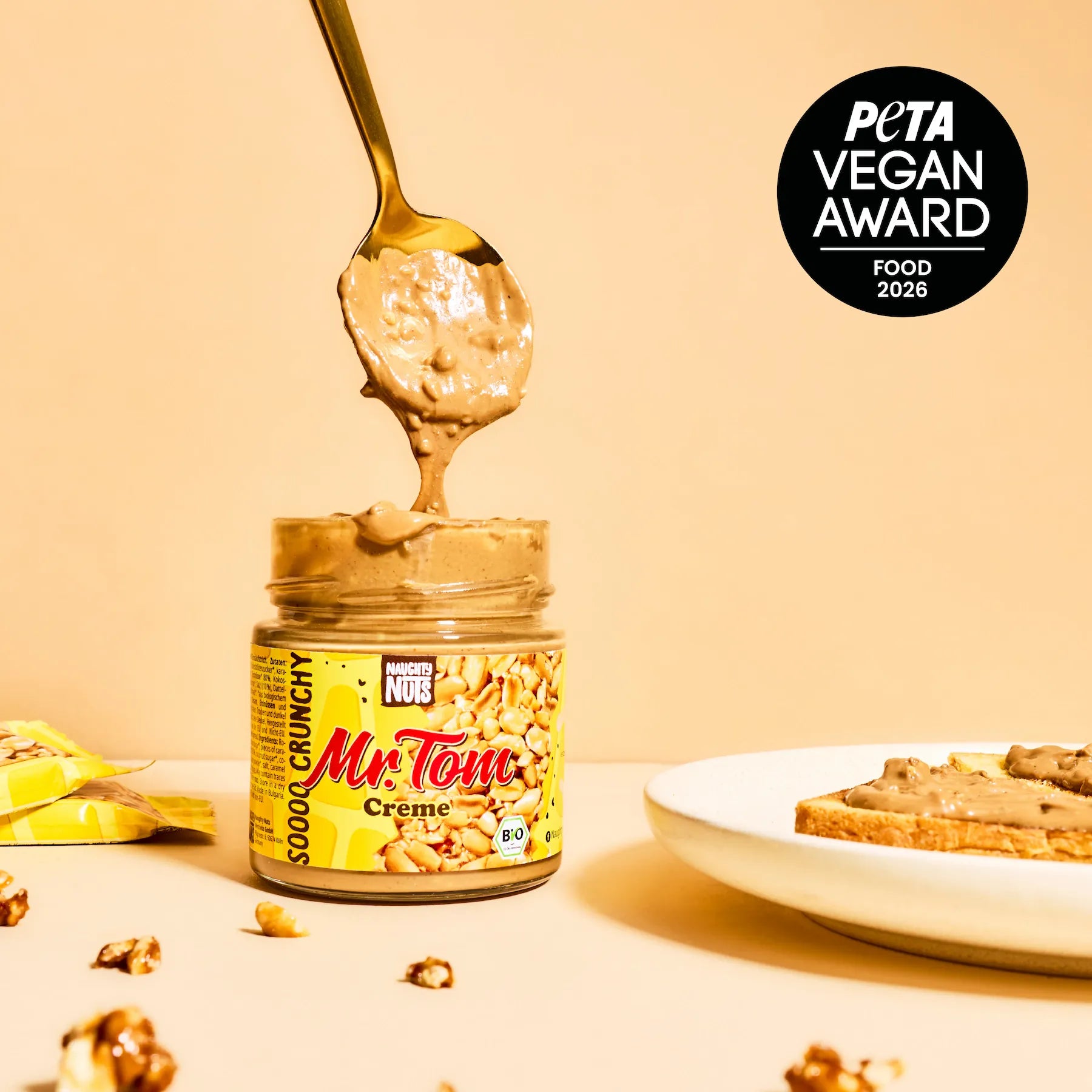 Mr Tom Creme Glas mit Löffel, PETA Vegan Award Logo und Toast mit Aufstrich