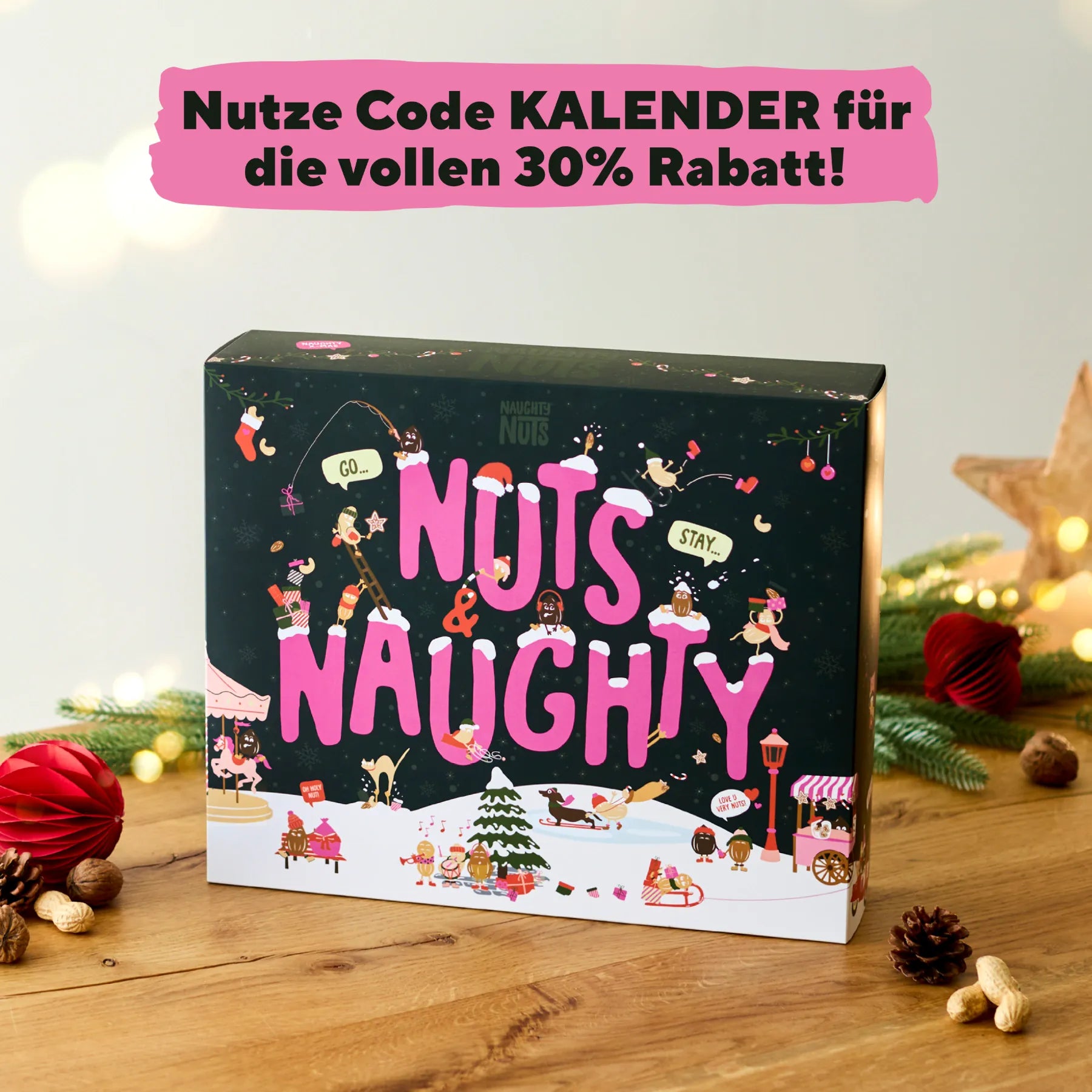 Adventskalender Deluxe 2026 mit weihnachtlichen Motiven auf einem Holztisch